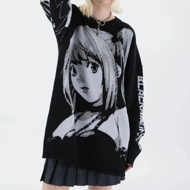 A woman wearing an oversized black sweater with a graphic print of an anime girl in monochrome.